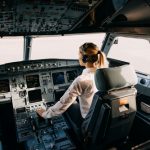Woman,pilot,sitting,in,aircraft,cockpit,,flying,the,plane.