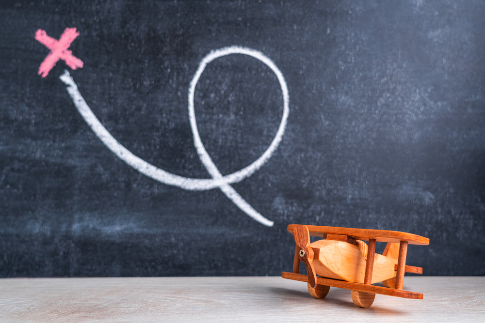 A,wooden,biplane,toy,on,the,background,of,a,blackboard