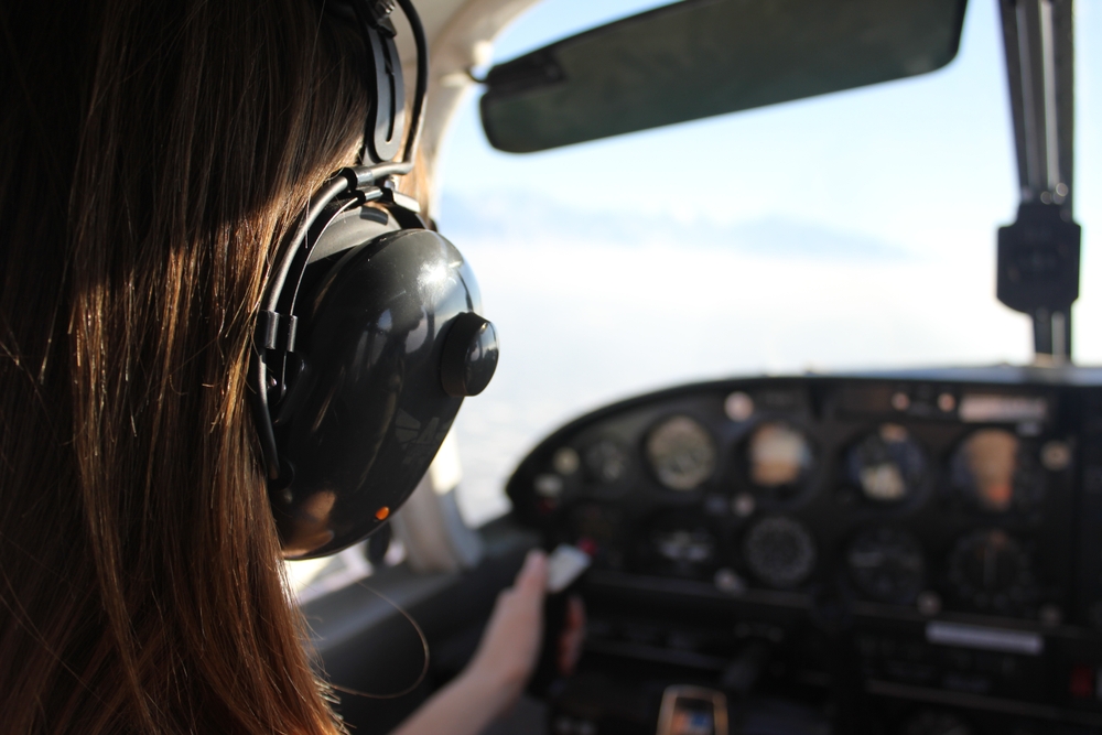 Back,of,pilot,flying,plane